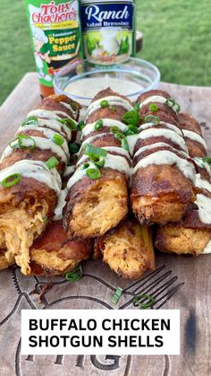 buffalo chicken shotguns with ranch dressing on a wooden table next to cans of ranch dressing