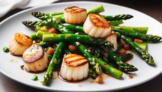 scallops and asparagus on a white plate