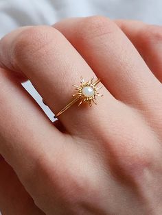 Gold Sunburst Adjustable Wire Wrapped Ring This dainty crystal beaded sunburst ring is handmade and perfect to be adjusted to any size. Thrive in your celestial core vibes or give this sweet sunshine ring as a gift to someone special! It looks amazing on its own of part of a set! ✨ DETAILS ✨ * 18 mm in diameter, adjustable * Material: white crystal bead, gold color wire If you have any questions, send me a message! 🌼 Star Wire Ring, Celestial Adjustable Open Ring Jewelry, Adjustable Celestial Open Ring Jewelry, Adjustable Celestial Crystal Ring With Gemstone, Adjustable Celestial Crystal Open Ring, Adjustable Celestial Opal Ring, Adjustable White Crystal Toe Ring, Handmade Adjustable Opal Ring As Gift, Adjustable White Crystal Ring With Birthstone