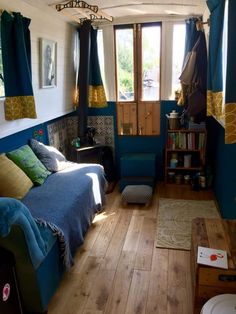 a bed room with a neatly made bed and wooden floors