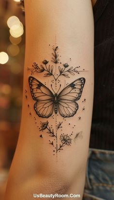 a woman's arm with a butterfly tattoo on it