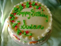 a birthday cake with the words happy birthday susan written in green frosting on it