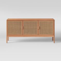 the sideboard is made out of wood and has wicker panels on one side