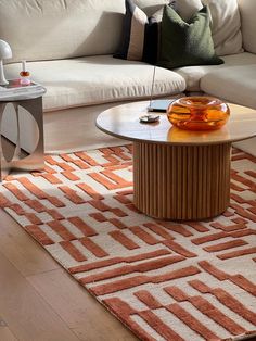 a living room with a couch, coffee table and rug