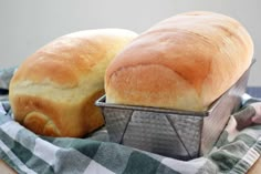 two loaves of bread sitting in a basket