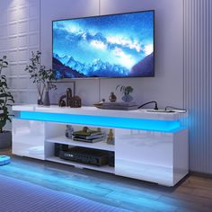 a flat screen tv sitting on top of a white entertainment center in a living room