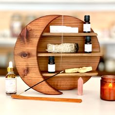 a wooden shelf with candles, essentials and other items on top of the table