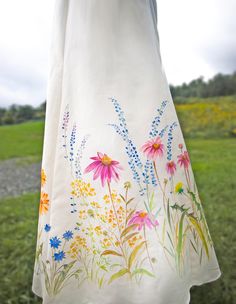 a white dress with colorful flowers painted on it