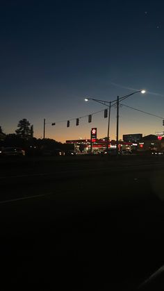 an intersection with traffic lights at night time