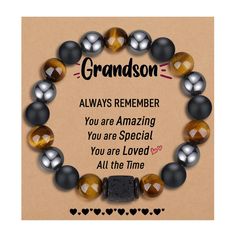 a bracelet with the words grandson on it and two black beads in front of an orange background