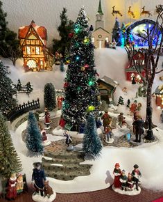 a christmas village with lots of trees and people