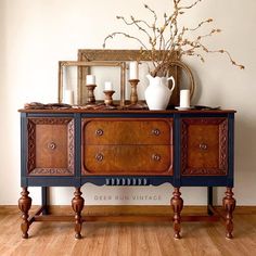 an old dresser with candles and vases on top