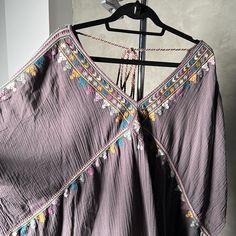 Gorgeous, Never Worn Boho Style Top. Can Be Worn As A Tunic Or Dress. Beautiful Embroidery Around The Top And Hems - Really Detailed Work. Ties In The Back. Relaxed, Oversized Fit - Size Small But I’m A Large And It Looks Cute On Me. Lovely Eggplant/Grey Color. Super Cute With Wide Legged Jeans And Boots! Purple Bohemian Top With Floral Embroidery, Bohemian Purple Top With Floral Embroidery, Purple Floral Embroidered Beach Top, Purple Floral Embroidery Beach Top, Purple Embroidered Dress For Vacation, Purple Hippie Beach Top, Bohemian Mauve Dress For Beach, Bohemian Mauve Beach Dress, Wide Legged Jeans