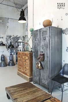 an old metal cabinet is in the middle of a room with chairs and other items