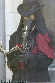 a person wearing a gas mask and holding a book