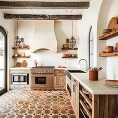 a kitchen with an oven, stove and counter top in the middle of it's room