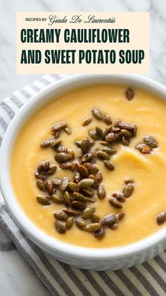 creamy cauliflower and sweet potato soup in a white bowl on a striped towel