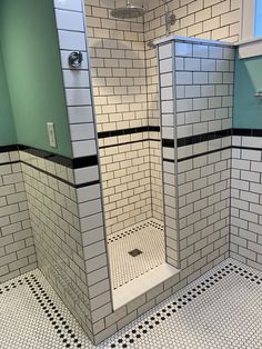 a white tiled bathroom with black and white tiles