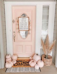 a pink door with some pumpkins on it