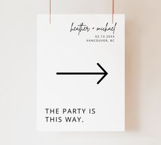 the party is this way sign hanging on a wall