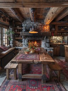 an old log cabin has a large dining table and fireplace in the center with potted plants on it