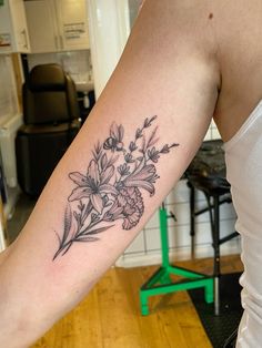 a woman with a flower tattoo on her arm