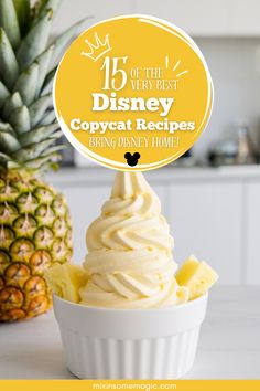 a cupcake topped with whipped cream next to a pineapple