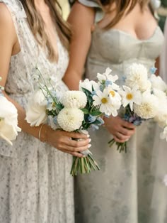 the bridesmaids are holding bouquets of white and blue flowers