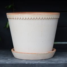 a white planter sitting on top of a table