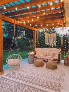 an outdoor living area is lit up with string lights