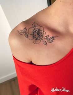 a woman's shoulder with a rose tattoo on the left side of her chest