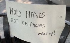 a sign that says hold hands not cliphones wake up on the back of a chair