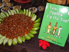 there is an apple pie with apples on top and a book about ten apples up on top