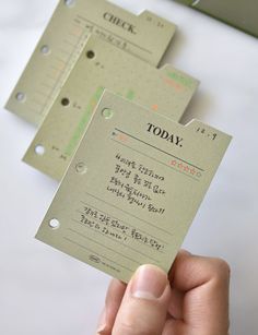 a person holding up some business cards with numbers on them and the words topax