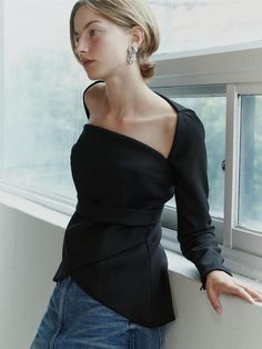 This product is a Square Neck Tulip Blouse that combines a structured square neckline with the soft, flowing lines of a tulip-shaped body, offering a blend of geometric and organic design elements. The blouse features a fitted waist that accentuates the silhouette, while the peplum detail adds a touch of drama and femininity to the overall aesthetic. Crafted to provide a sophisticated and polished look, this piece is perfect for both formal and casual settings. - The blouse boasts a square neckline that frames the collarbones and lends a modern edge.- A peplum waist creates a flattering tulip-like silhouette that enhances the garment's elegance.- The long sleeves add a traditional touch, balancing the contemporary neckline and fitted bodice.- Constructed with a blend of materials that Formal Off-shoulder Tops For Fall, Soft Feminine Outfits Aesthetic, Fitted Top With Asymmetrical Neckline For Workwear, Modern Fitted Top With Asymmetrical Neckline, Evening Tops With Structured Shoulders And Long Sleeves, Elegant Fitted Top With Asymmetrical Neckline, Party Tops With Structured Shoulders And Long Sleeves, Long Sleeve Tops With Structured Shoulders For Evening, Long Sleeve Tops With Structured Shoulders For Party