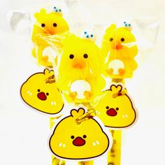 some little yellow chicks are hanging from plastic bags