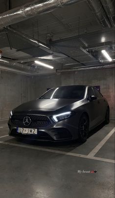 a black car parked in a parking garage