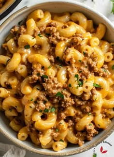 a bowl filled with macaroni and cheese on top of a table