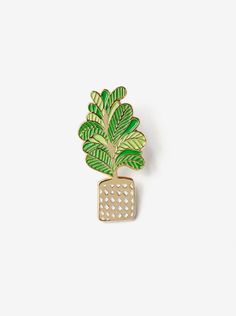 a brooch with a green plant on it