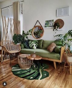 a living room filled with lots of plants and wicker furniture on top of hard wood floors