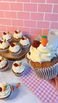 cupcakes with frosting and candies are on the table