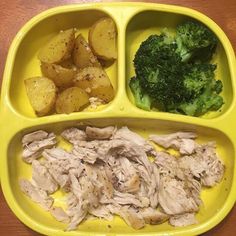 a yellow plate with some meat and vegetables in it on a wooden table next to broccoli