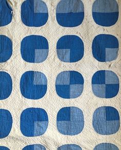 a blue and white quilt with circles on it