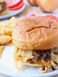 a close up of a sandwich on a plate with chips