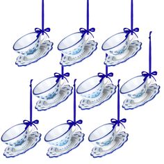 twelve glass teacups with blue ribbons tied around them