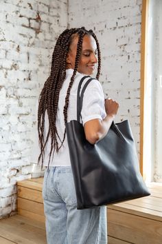 "Our black leather tote bag for women is made of top grain leather which will gain patina in time. This casual shoulder bag is very roomy and will hold all your everyday essentials. It has two big pockets inside which help to organise all things as well. Handles are designed for shoulder wearing. You can add zipper on top or adjustable shoulder strap. I f you need any other customisation, please contact me. Large (fits 15\" laptop) Width top - 42 cm / 16,5 inch Width bottom - 33 cm / 12,6 inch H Black Smooth Grain Shoulder Bag For Daily Use, Black Vegetable-tanned Shoulder Bag For Everyday Use, Elegant Black Laptop Tote Bag, Modern Black Laptop Bag Tote, Black Vegetable-tanned Bags For Daily Use, Black High-capacity Tote Bag, Handbag Big, Black Leather-lined Tote Hobo Bag, Black Leather-handled Laptop Tote Bag