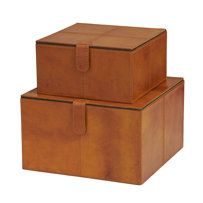 two brown leather boxes sitting on top of each other