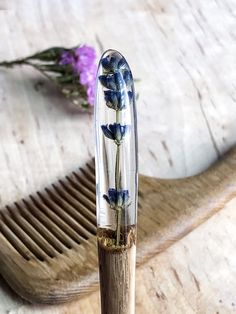 a pen with flowers in it sitting on top of a wooden table