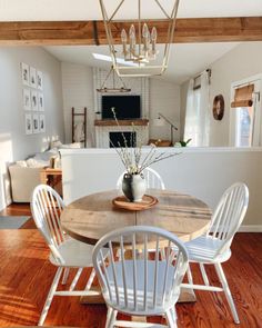 a dining room table with white chairs around it