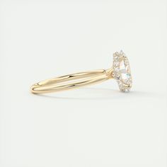 a yellow gold ring with an oval cut diamond